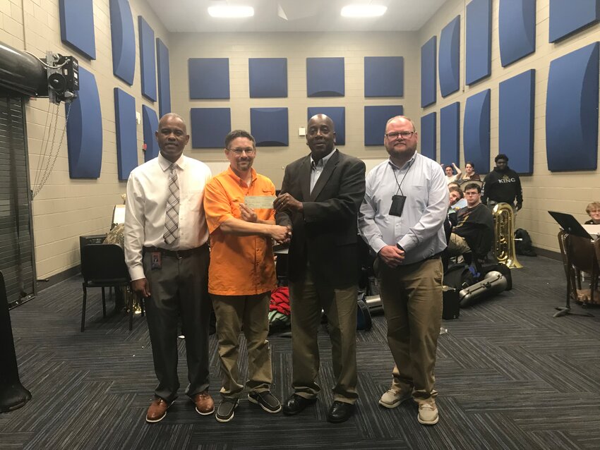 Pictured above, from left, are Assistant Principal LaShon Horne, Band Director Daniel Wade, Johnny Beckwith of the club, and Assistant Principal Brent Pouncey.